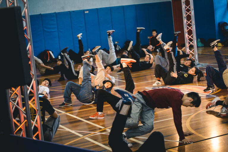 Students learning a breaking move in a workshop